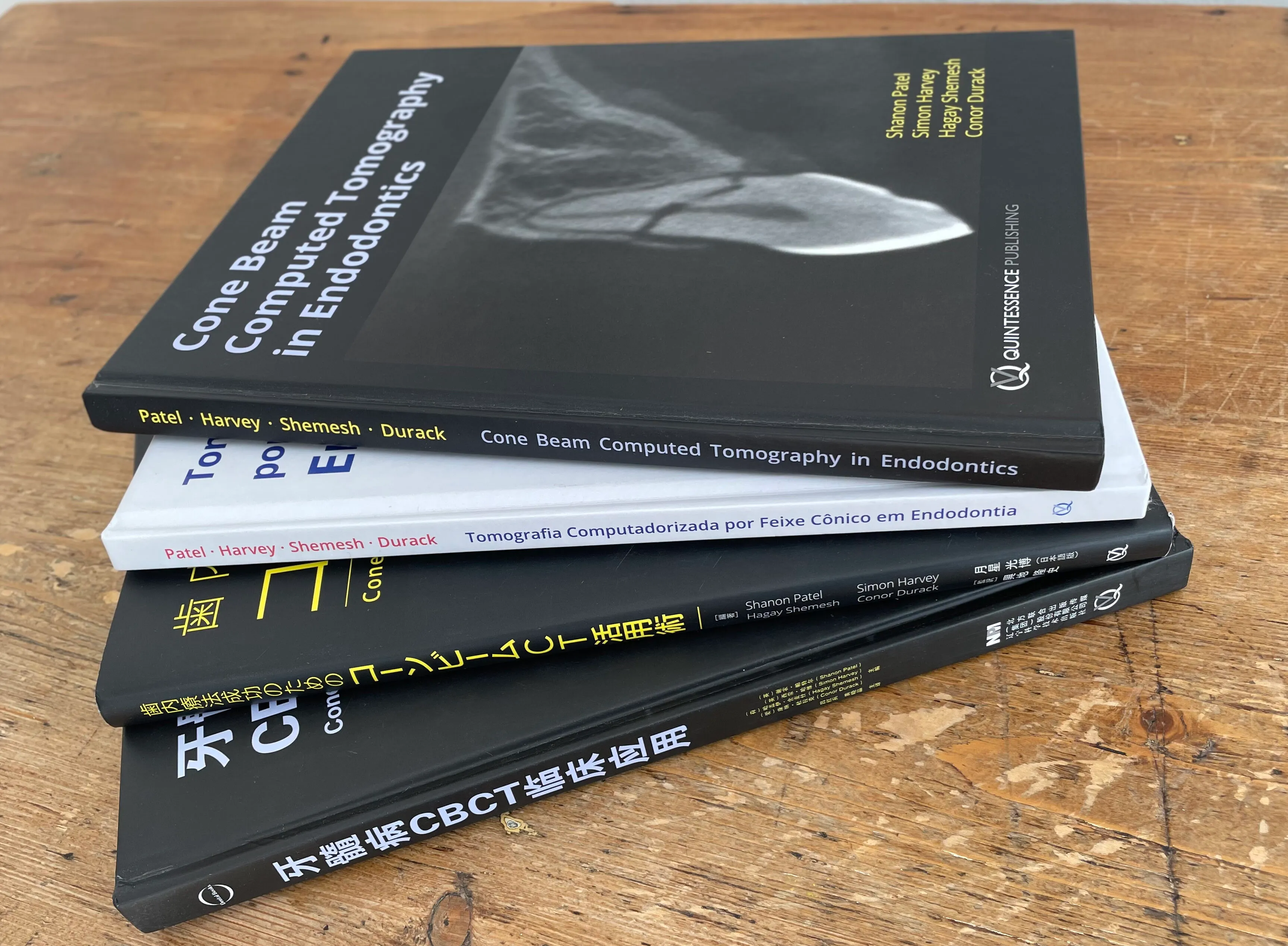 Professor Patel's co-authored textbooks on cone beam computed tomography in endodontics, published in multiple languages