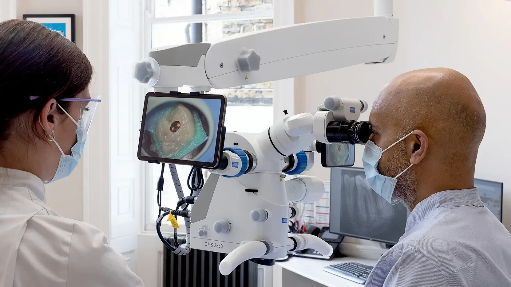 Professor Patel performing root canal treatment under the operating microscope